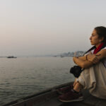Photographer sitting on a boat on the River Ganges