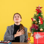 front-view-peaceful-girl-sitting-table-putting-hand
