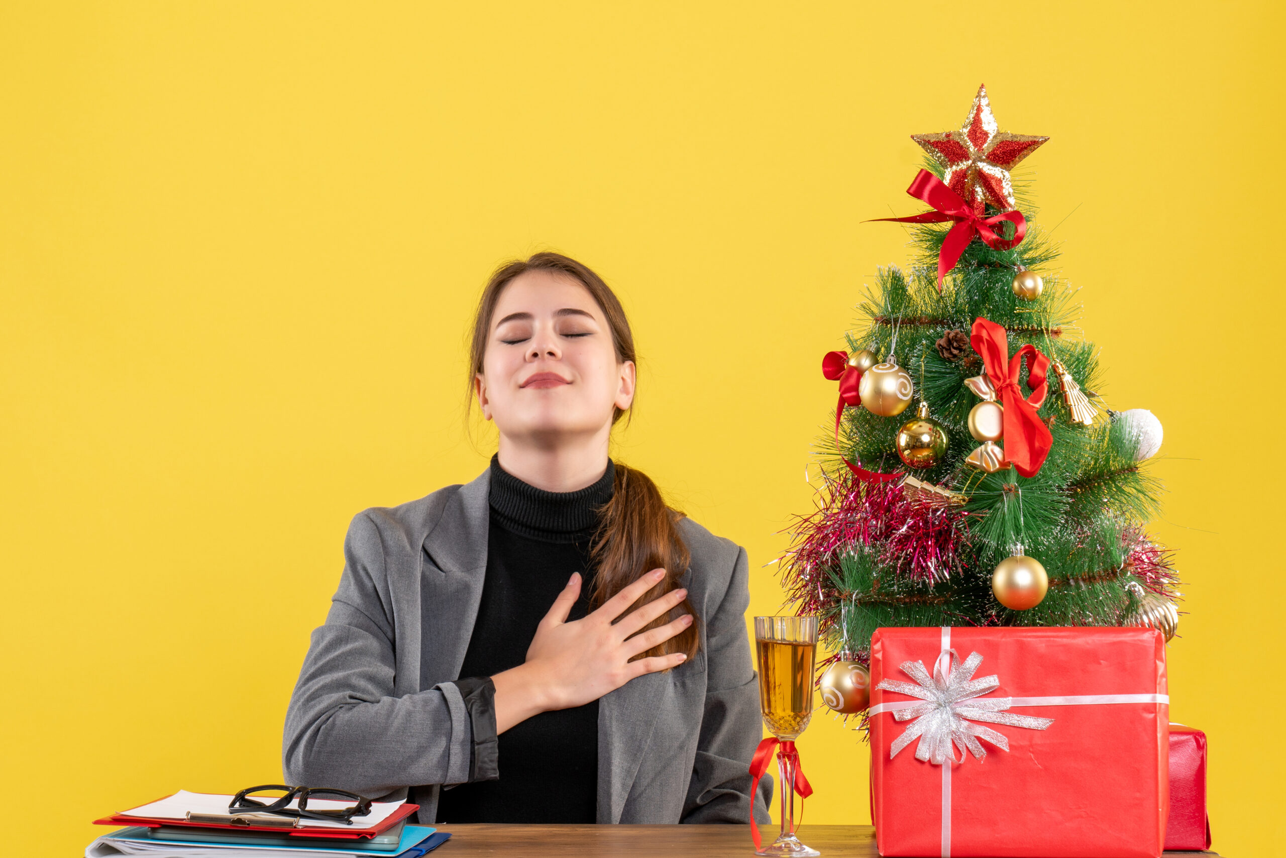 front-view-peaceful-girl-sitting-table-putting-hand