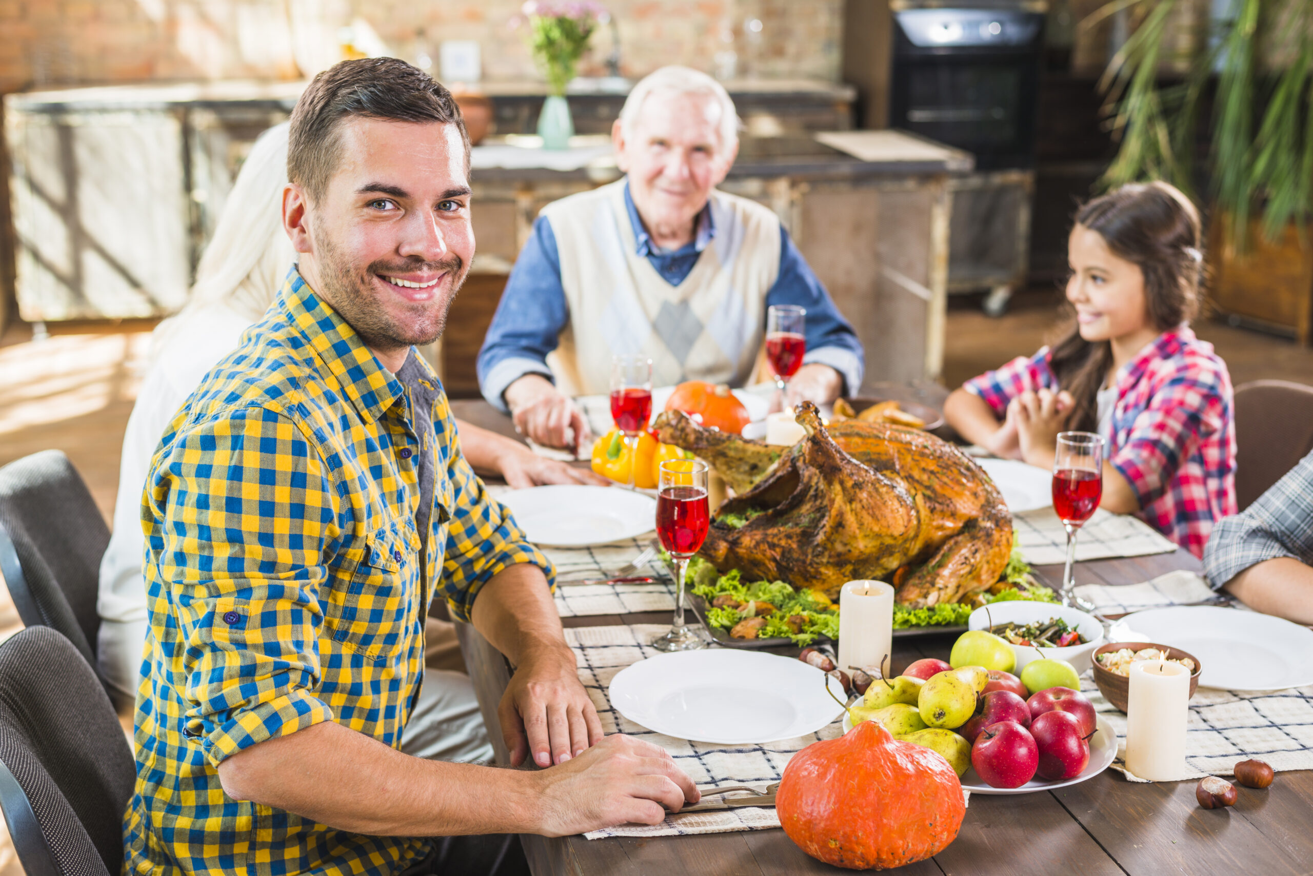 man-sitting-table-near-family