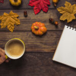 man-writing-autumn-decorated-workplace